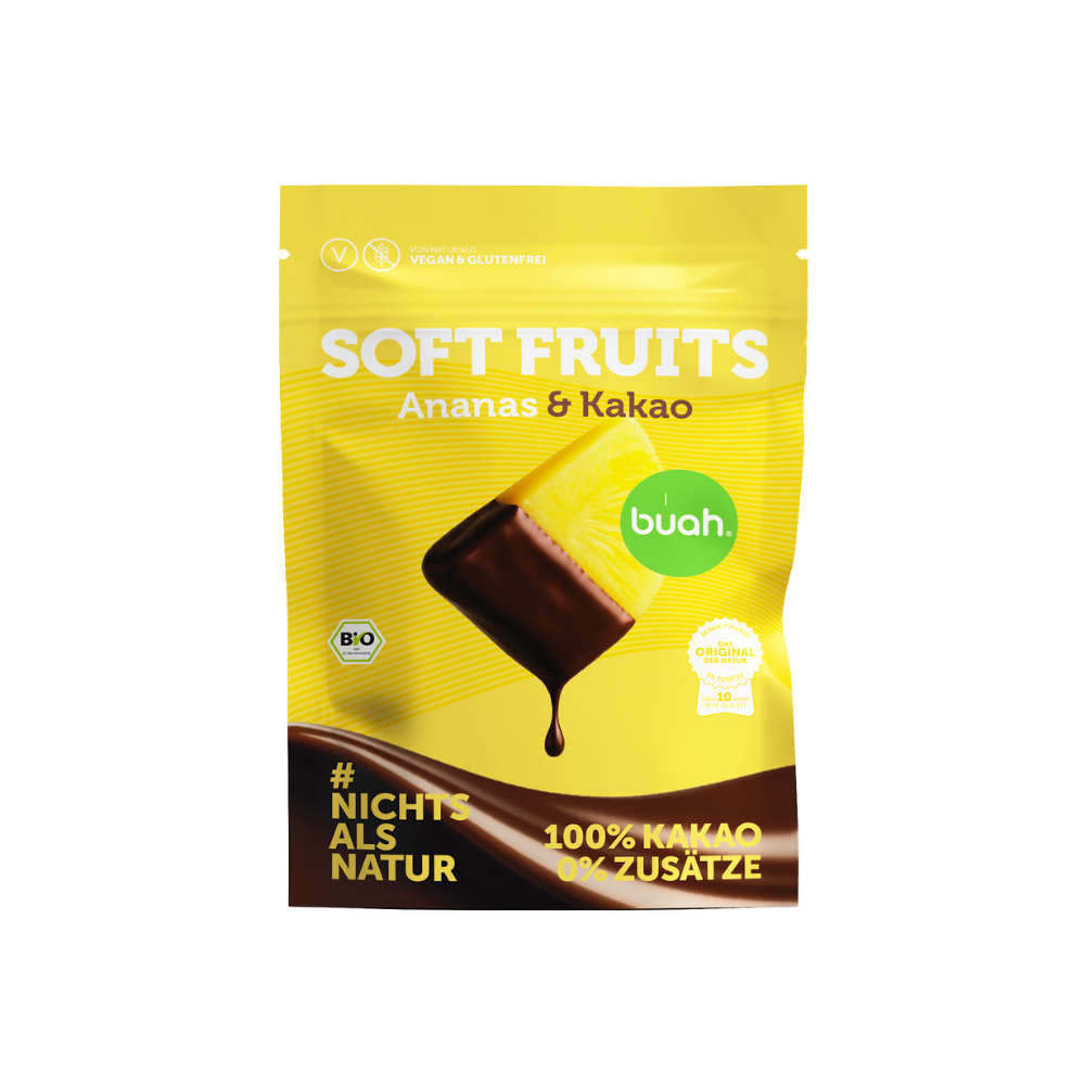 buah Bio Soft Fruits Ananas & Kakao in einer gelben wiederverschließbaren Beutel-Verpackung mit 100 % Kakao-Überzug ohne Zusätze